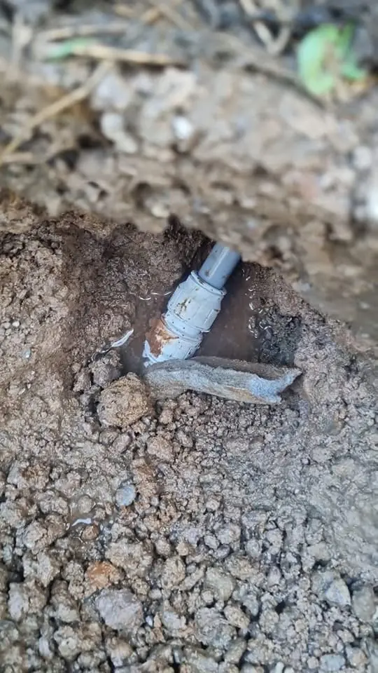 Plastic pipe coupling in wet soil on a buried water line